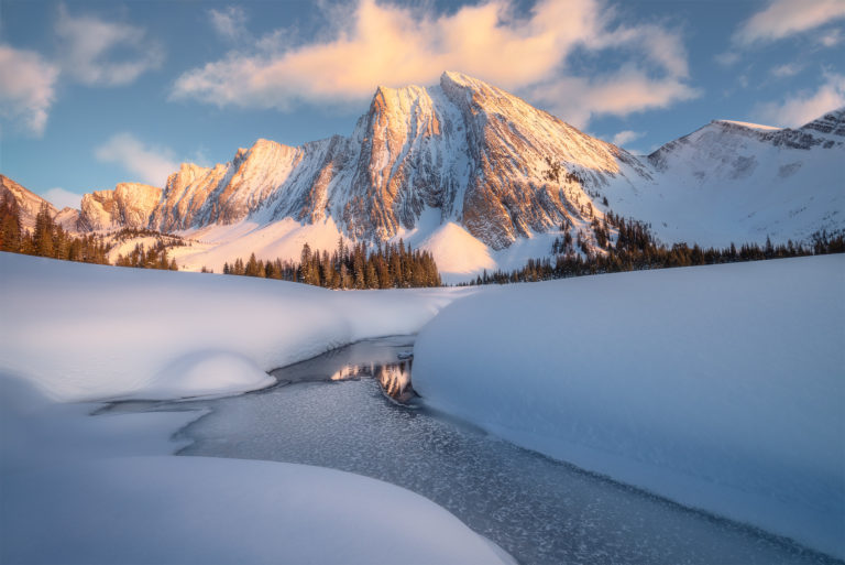 A landscape photograph of Mount Chester in the Canadian Rockies during a winter sunset