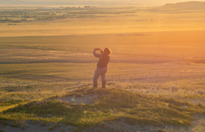 A landscape photography workshop guest taking a selfie in Grasslands National Park, Canada