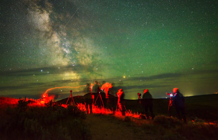Night photography workshop guests under the milky way in Canada