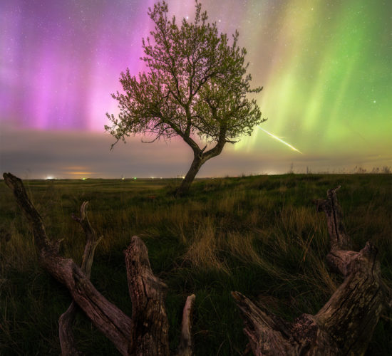 A night photograph including aurora borealis and a bright meteor in Saskatchewan