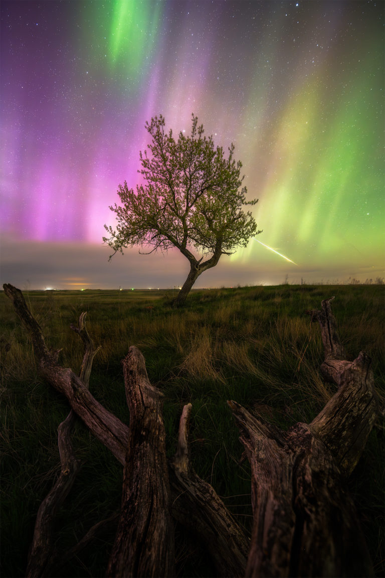 A night photograph including aurora borealis and a bright meteor in Saskatchewan