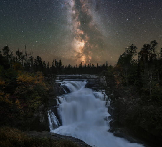 A night photograph of the milky way over Nistowiak Falls in north Saskatchewan