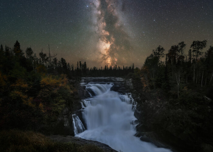 A night photograph of the milky way over Nistowiak Falls in north Saskatchewan