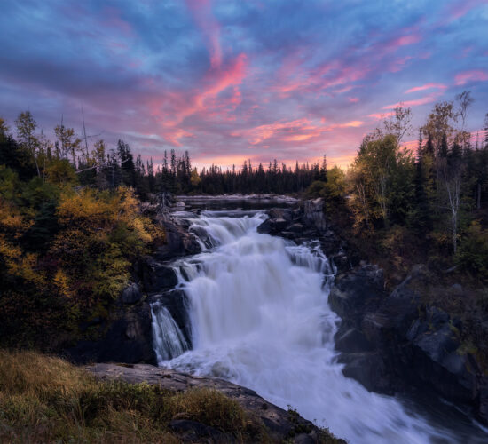 A sunset photograph of Nistowiak Falls in northern Saskatchewan