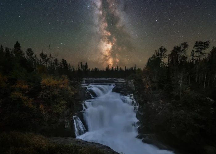 A night photograph of the milky way over Nistowiak Falls in northern saskatchewan