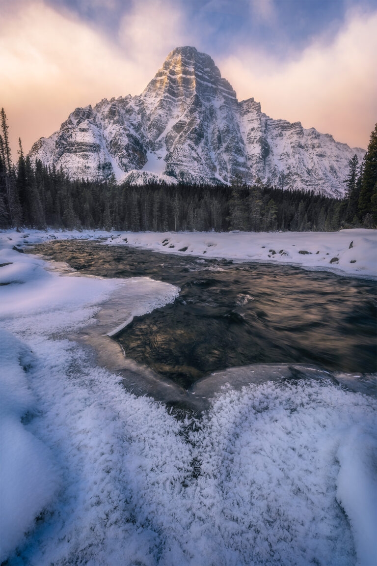 A winter photograph of the Canadian Rockies in Banff National Park of Mount Chephren in morning light at the base of Waterfowl Lakes