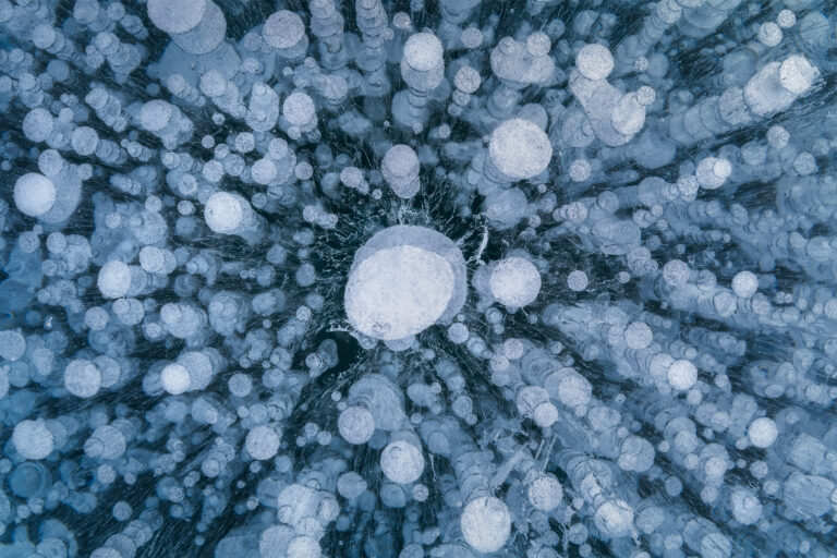 An intimate landscape photograph of the ice bubbles on Abraham Lake