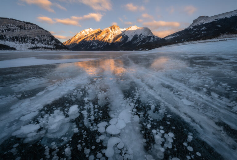 A winter landscape photograph of the Canadian Rockies at Spray Lakes with beautiful morning light on the mountains